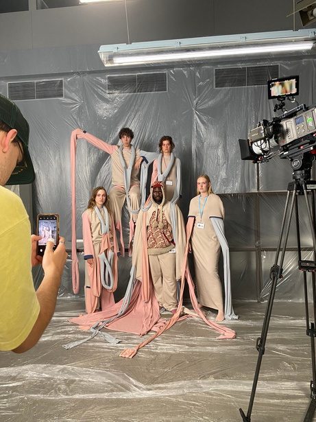 Models on set wrapped in fabric