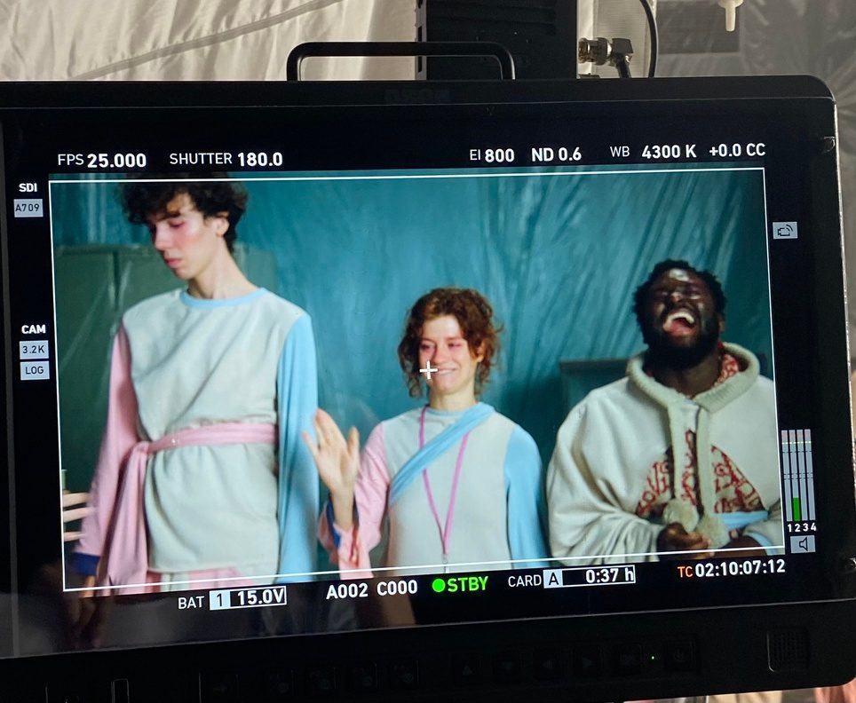 Camera monitor showing three performers