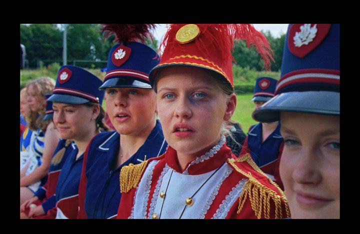Marching band members in red uniforms