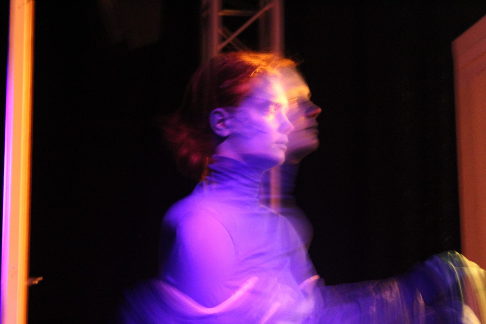 Blurred performer in purple light