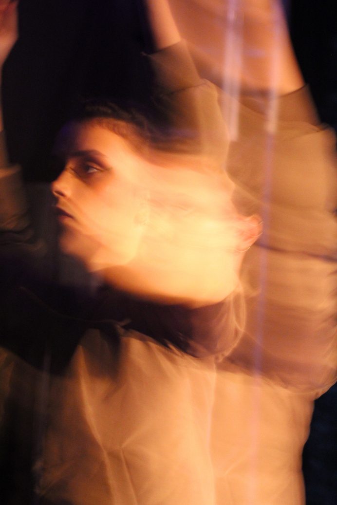 Blurred performer in warm light