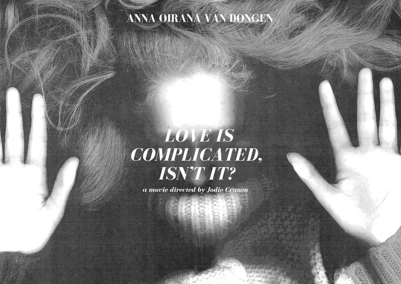 Black and white poster with hands against glass