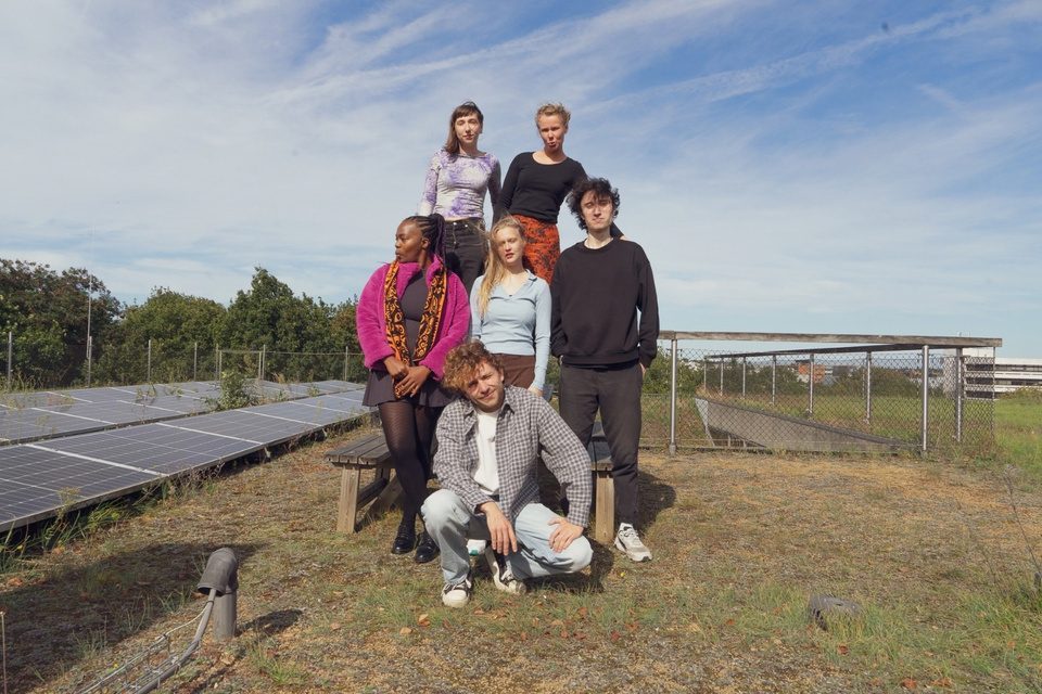 The SUB creators standing in a field of solar panels